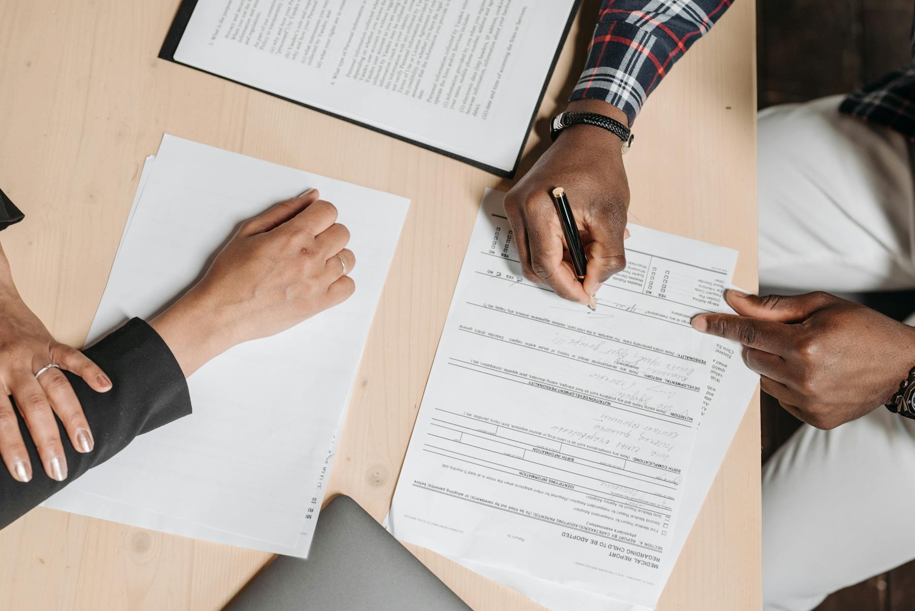Accountant reviewing financial documents with a client in an office
