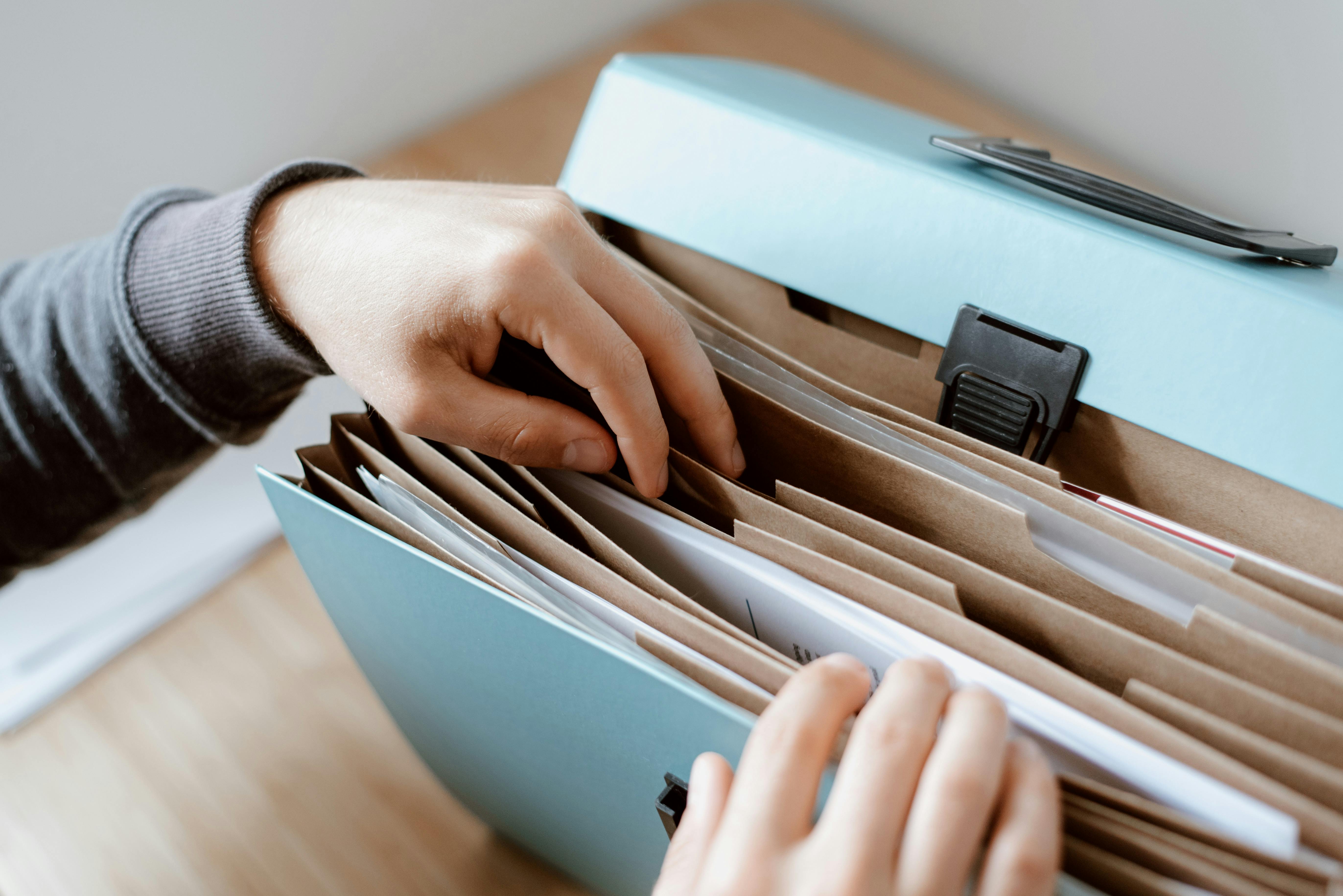 Organized blue file folder with neatly sorted planning documents